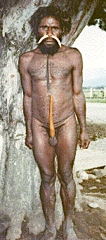 [Dani man wearing gourd koteka and pig tusk nose pieces outside hotel in Wamena, Baliem Valley, Irian Jaya, Indonesia: 28k]