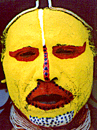 [Closeup of Huli warrior with bold yellow face paint, accented by red, black and white around eyes, nose and mouth: 30k]