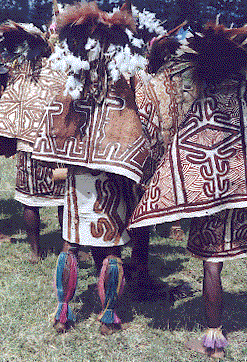 [terra cotta and sienna on white geometric patterned tapa bark-cloth capes: 51k]