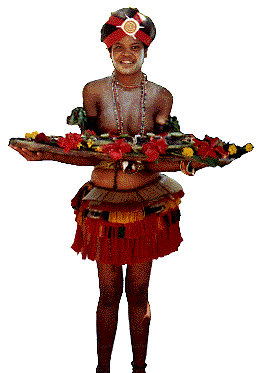 [Trobriand girl in multi-colored layered grass skirt holding wooden bowl of food decorated with flowers: 16k]